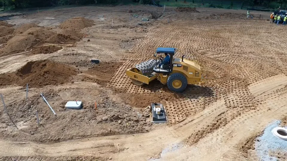 Compaction roller viewed from above on a prepared site.
